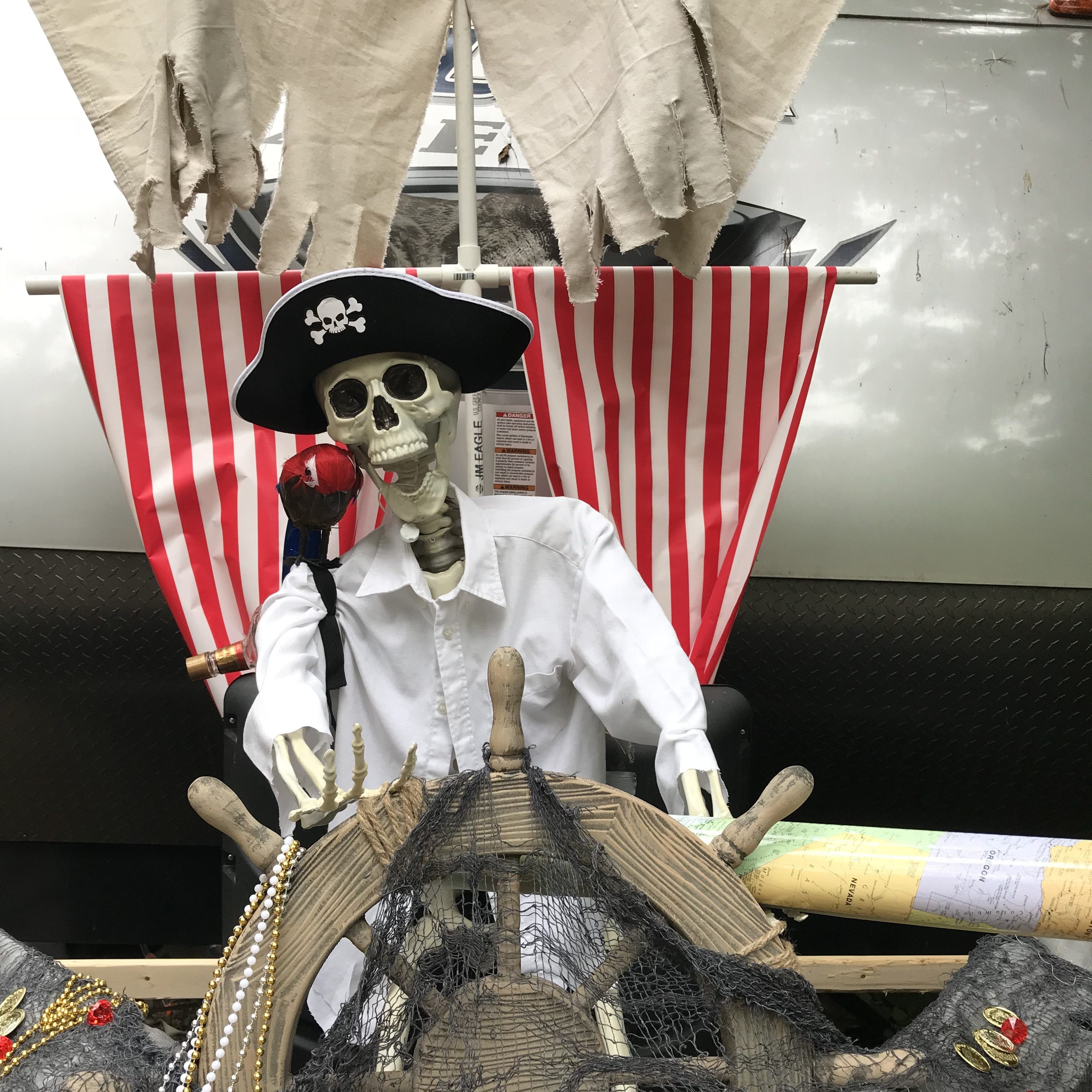 pirate skeleton holding a ship wheel in front of an rv