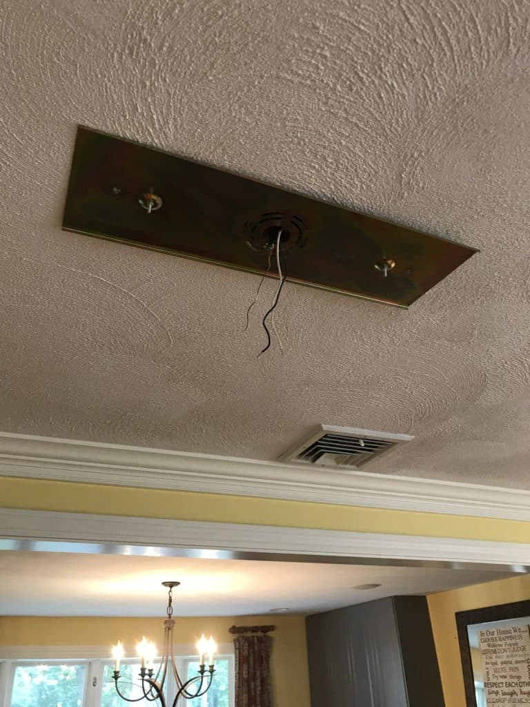 attaching the ceiling plate to hang the planter chandelier