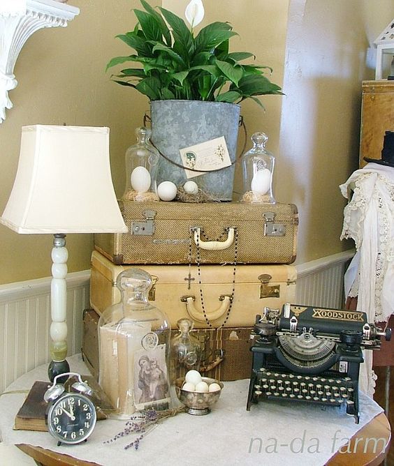 stacked suitcases with plants and accessories