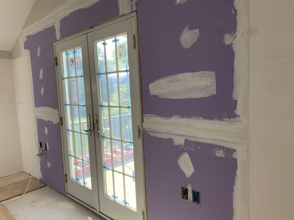 new door with sheetrocked walls