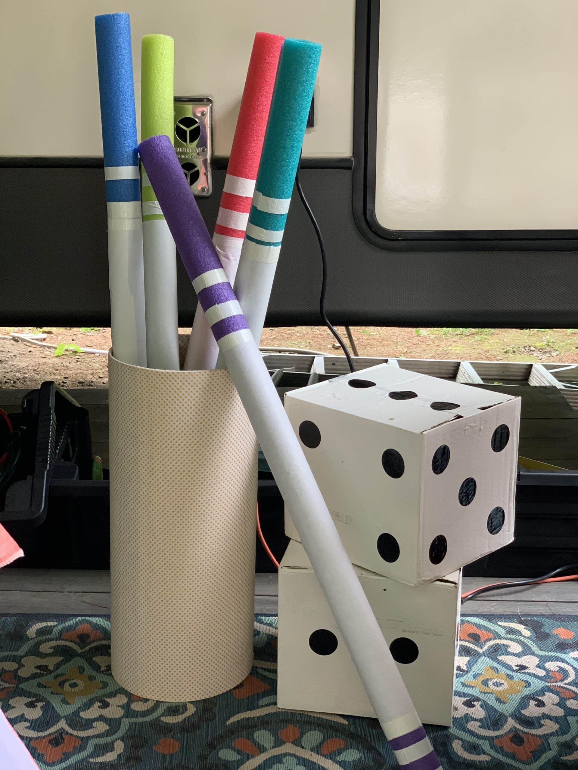 Large markers made from pool noodles and cardboard box dice for a Toy Story Party prop idea