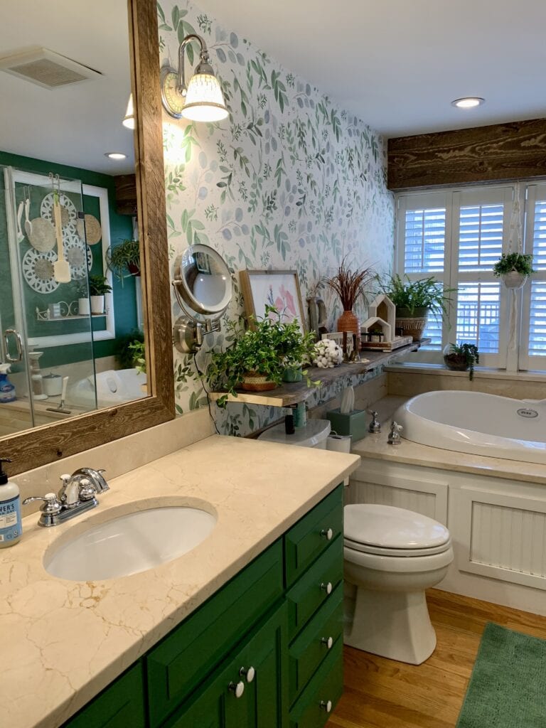 Boho style bathroom update with wallpaper, live edge shelf, and lots of plants