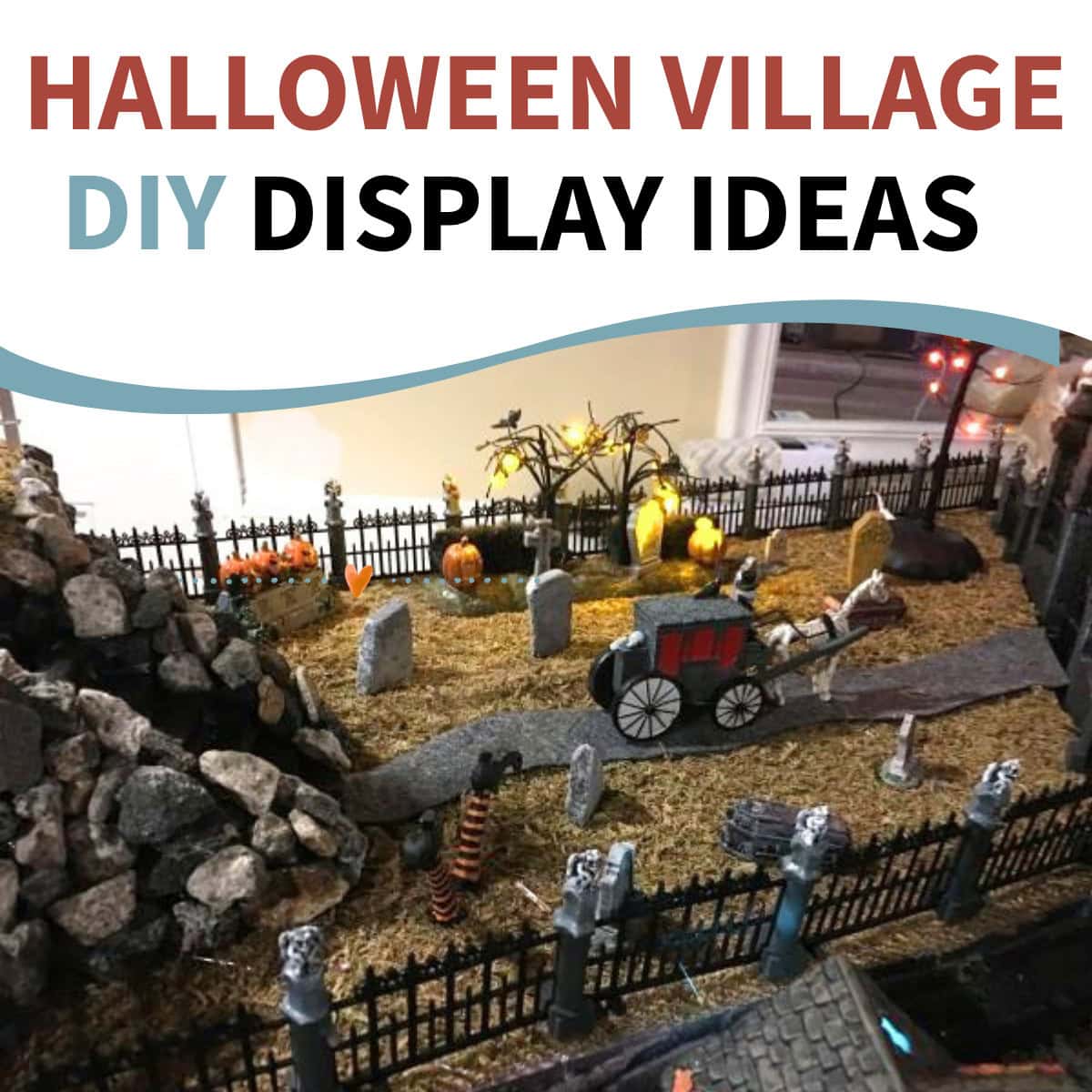 DIY Halloween village display with a cemetery scene, carriage, fencing, rocks, lights, and miniature landscaping.