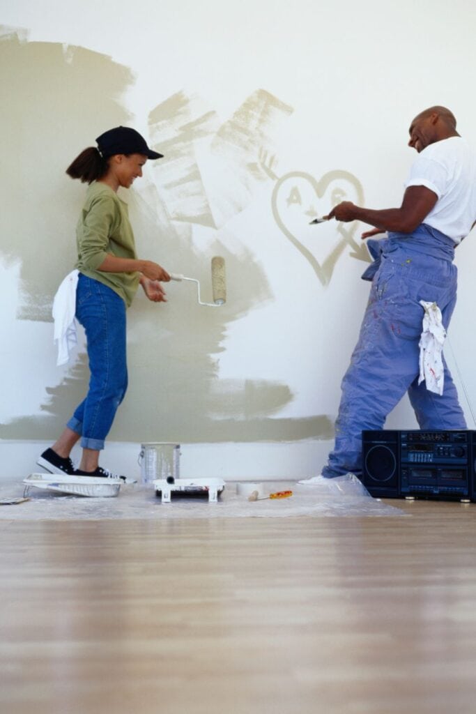 couple painting a wall with a heart