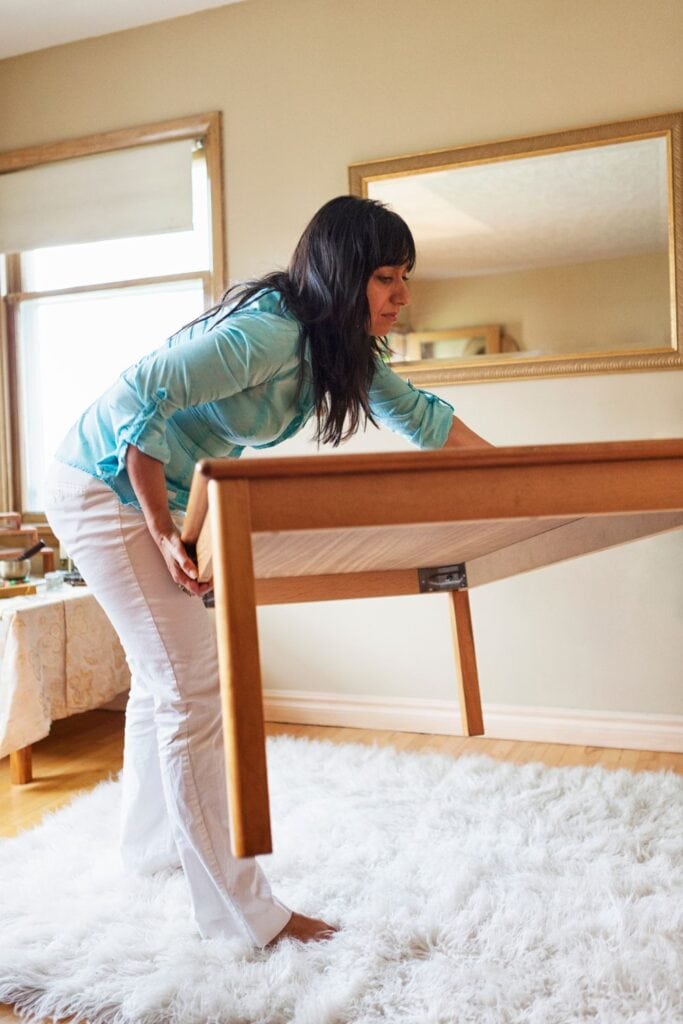 woman moving furniture around