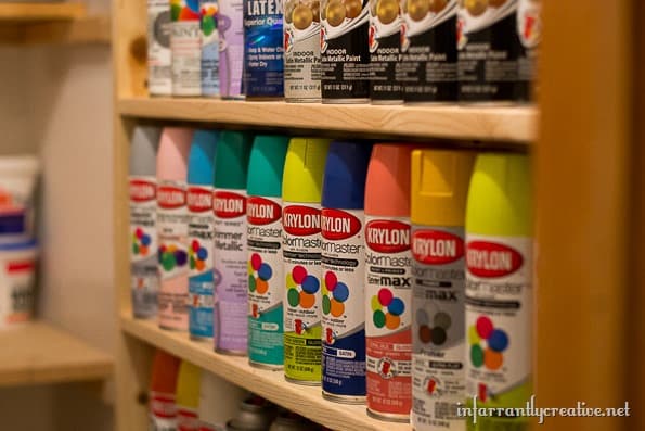 spray paints organized on a shelf